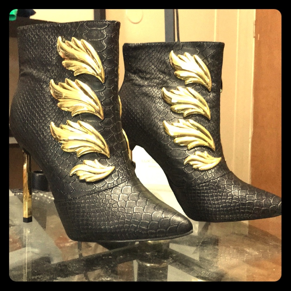 Black winged tip high heel boots.